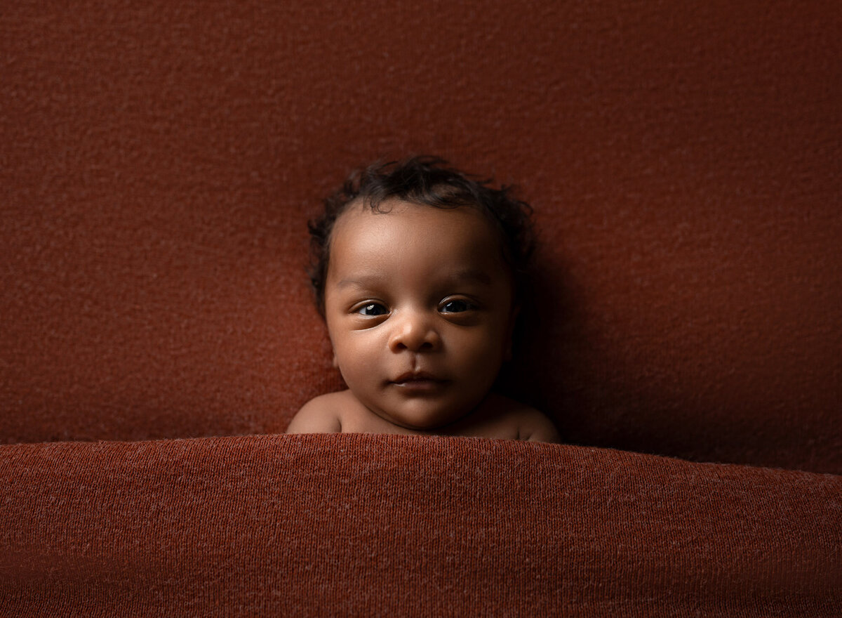 Newborn baby brown wrap cozy setup Austin professional maternity photographer