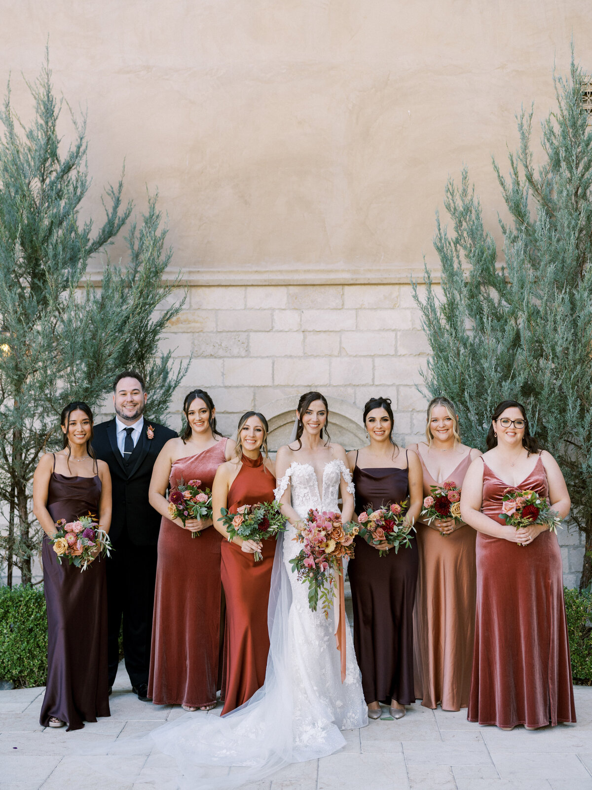 Chic bridal party in rich terracotta and mauve tones, captured in Santa Barbara with timeless, Tuscan-inspired elegance.
