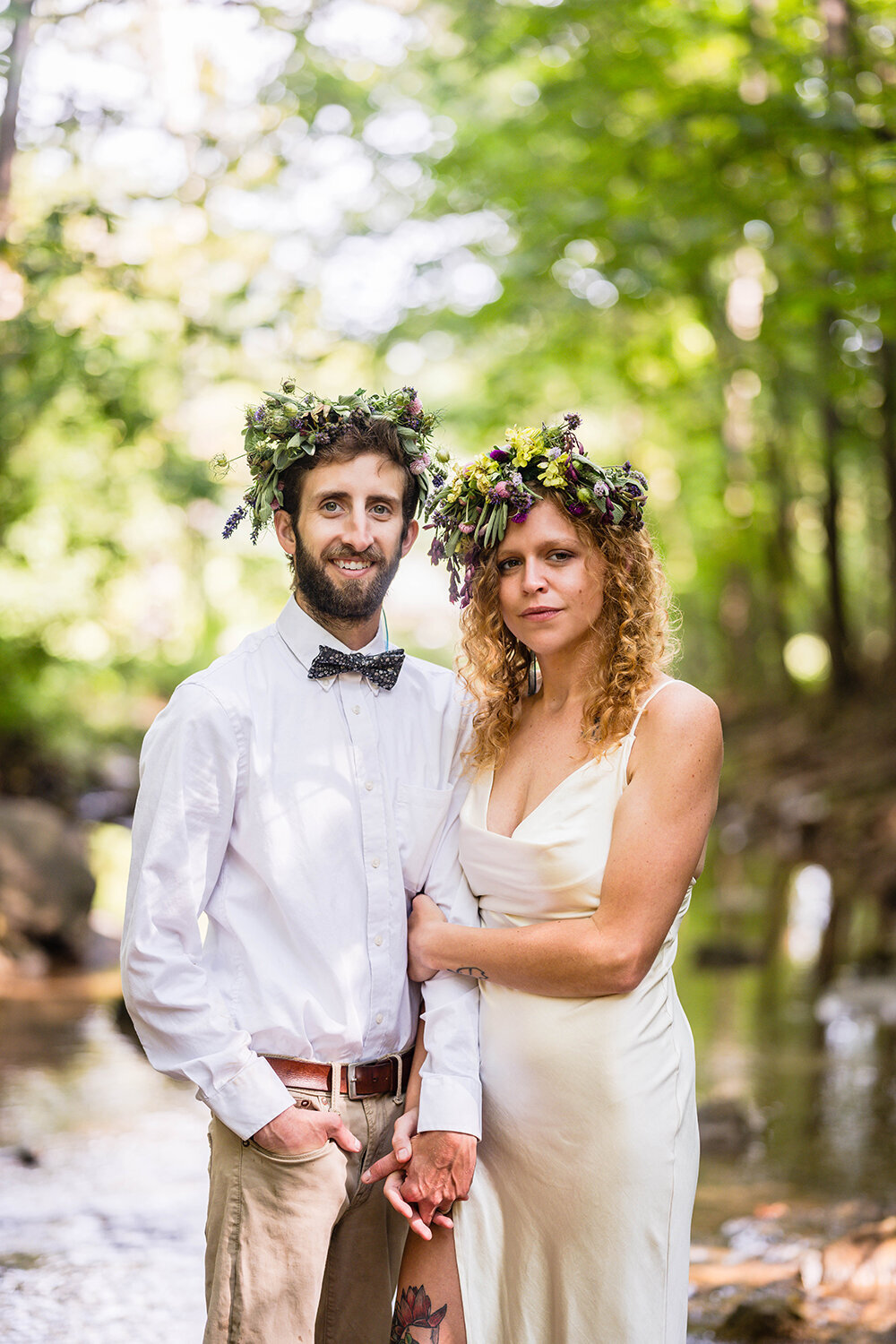 A newlywed couple holds hands and smiles for a formal portrait at Fishburn Park on their elopement day in Roanoke, Virginia.