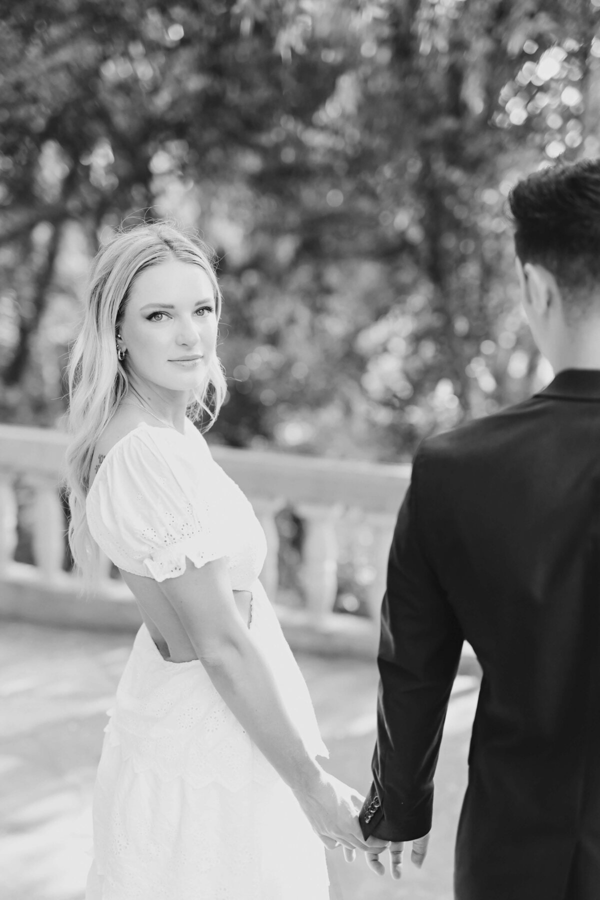 woman dressed in white dress for engagement session