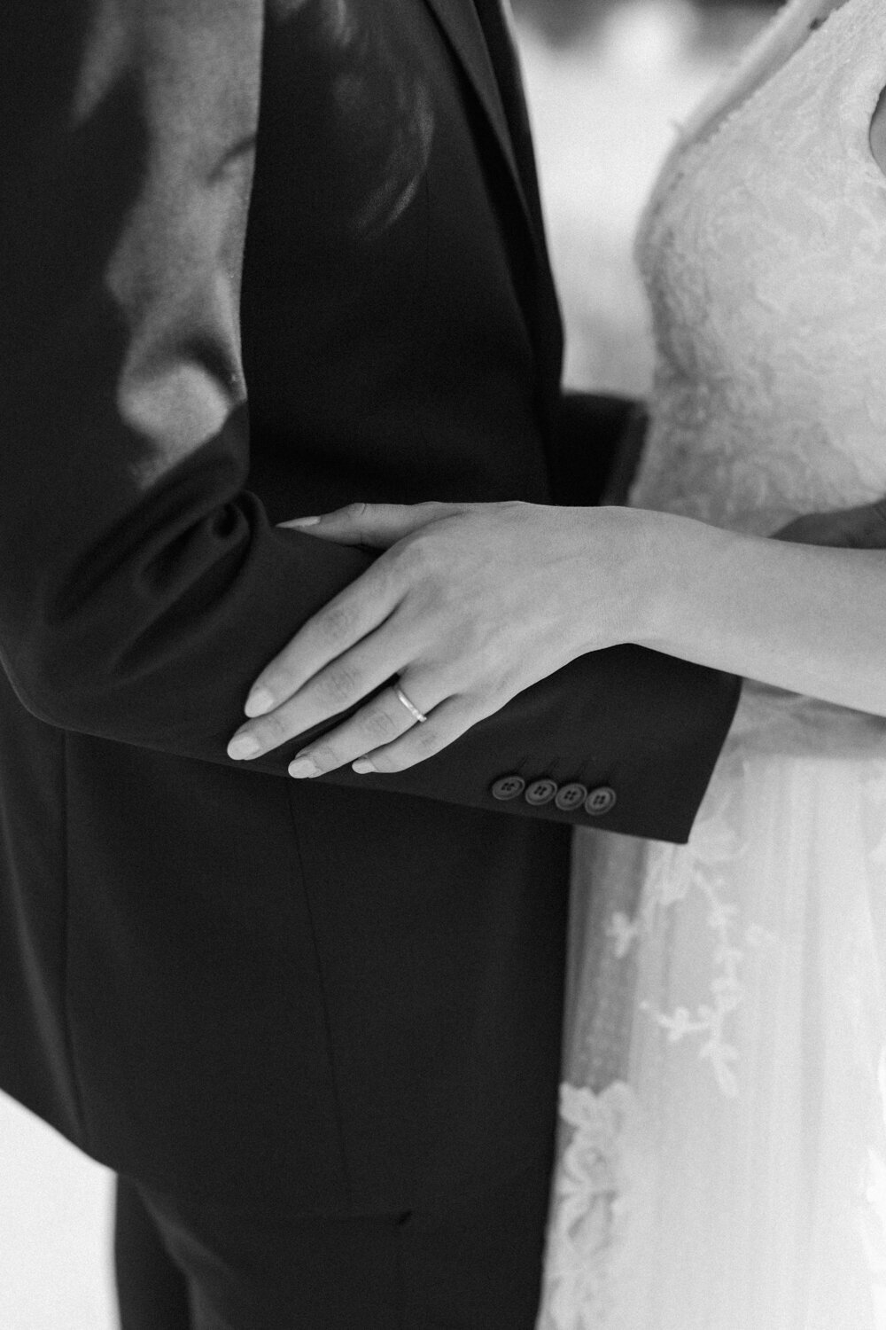 close up of brides hand showcasing wedding ring