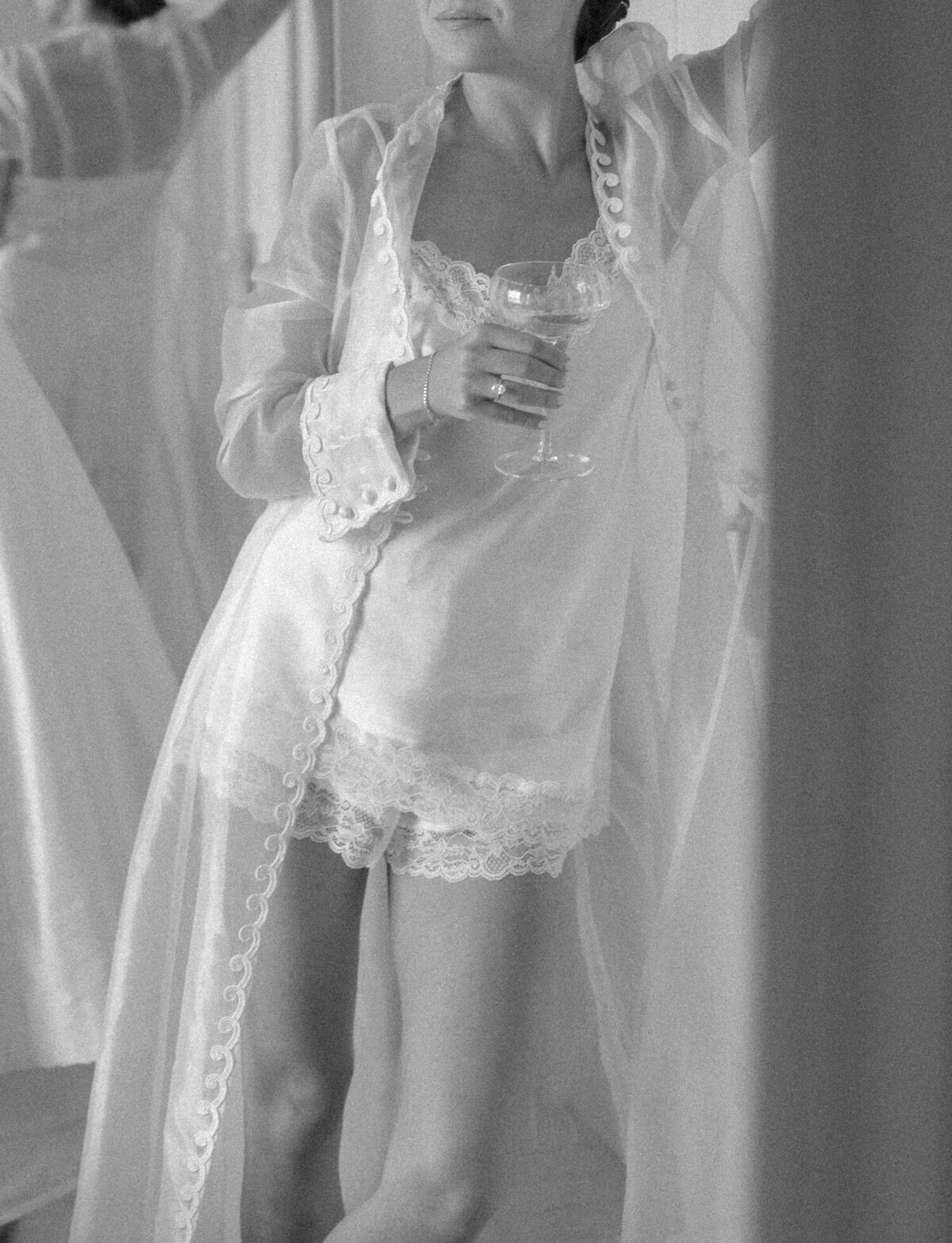Soft, poetic grain fills a photo of a bride's getting ready outfit; silk and lace robe & lingerie set made from her mother's wedding dress