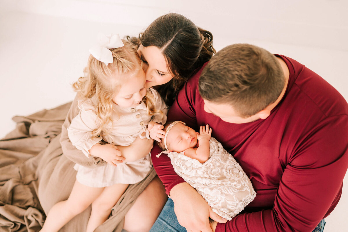 parenting cuddling newborn and toddler in Springfield MO newborn photography studio