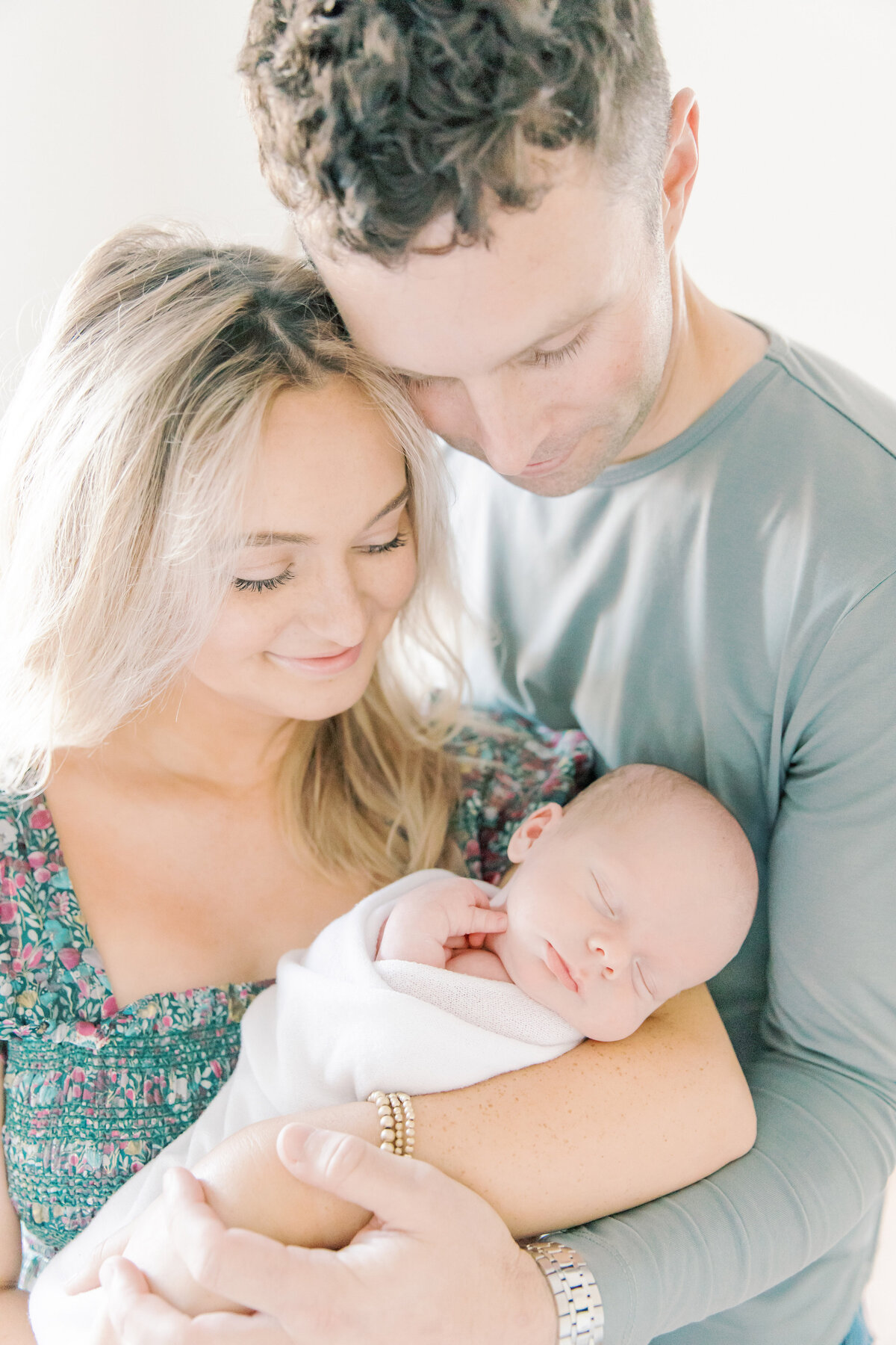 mom and dad holding newborn son during charlotte newborn session