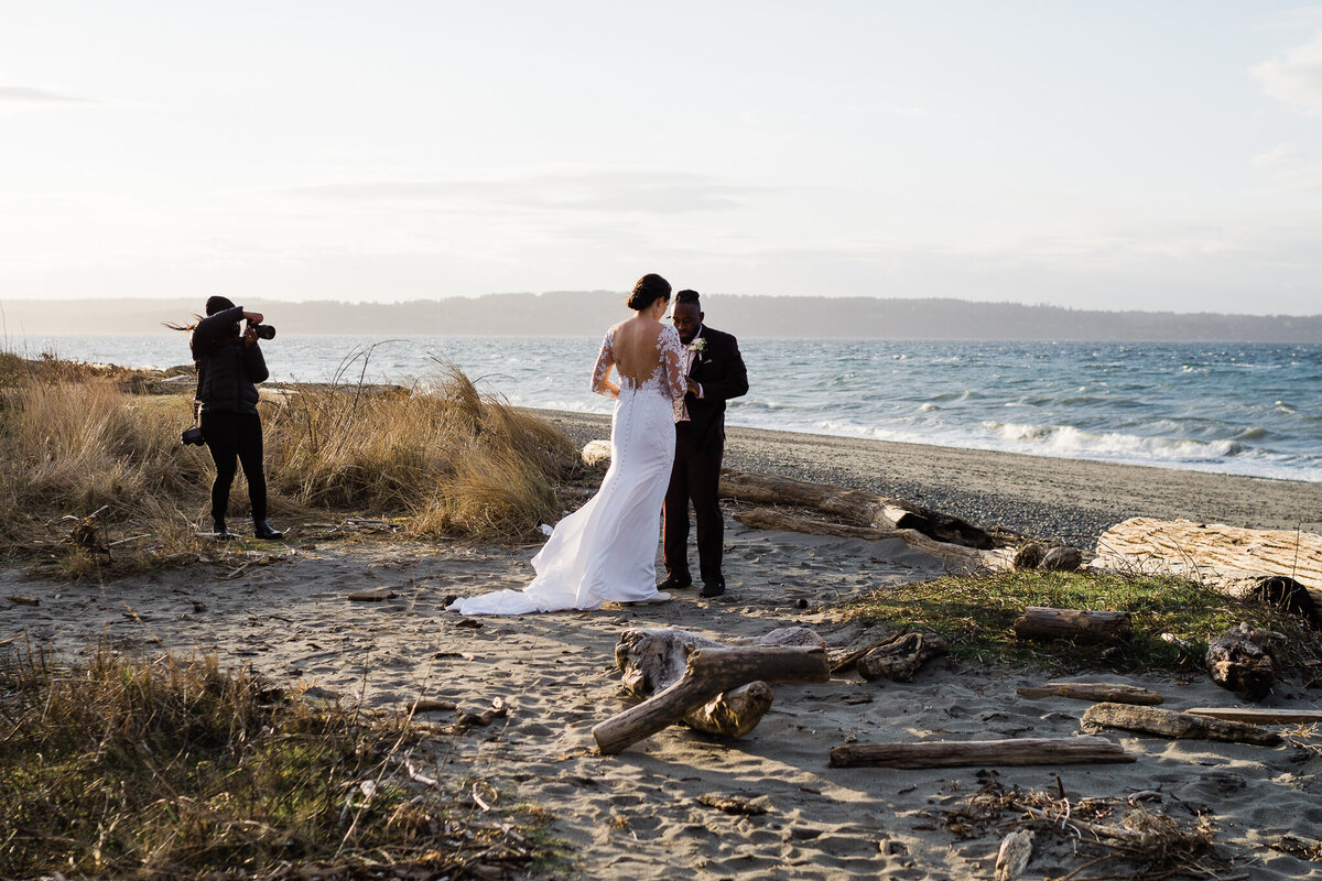 interracial couple exchange vows on beach