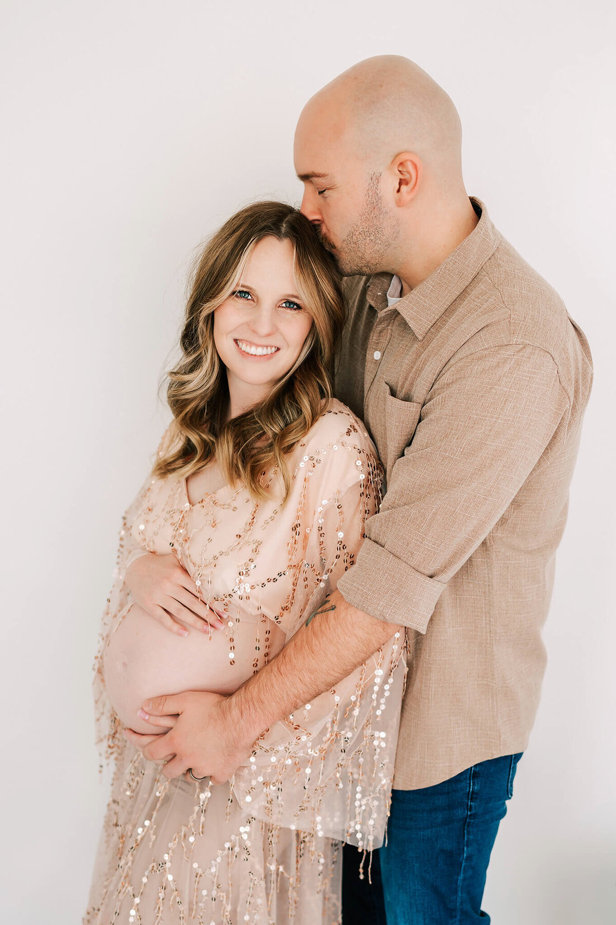 pregnant couple cuddling during maternity photography session in Joplin MO