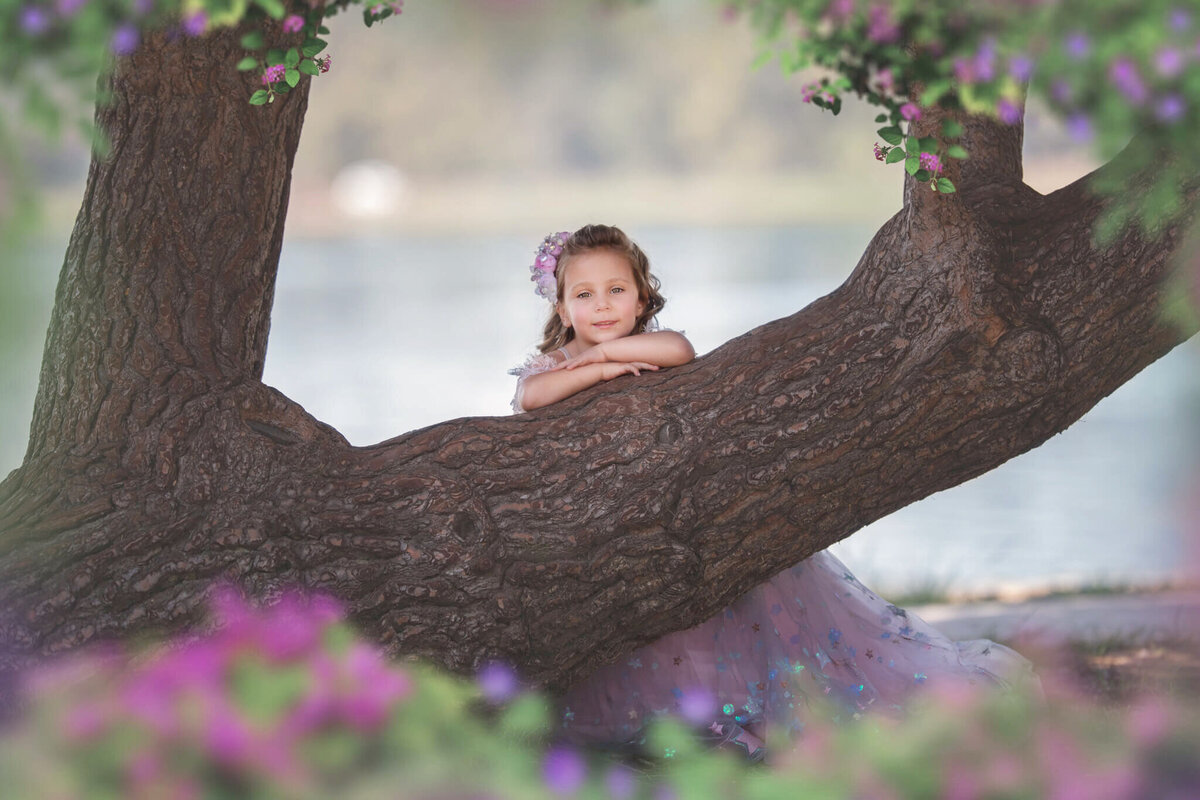 Young girl leaning on a tree in Lake Balboa park