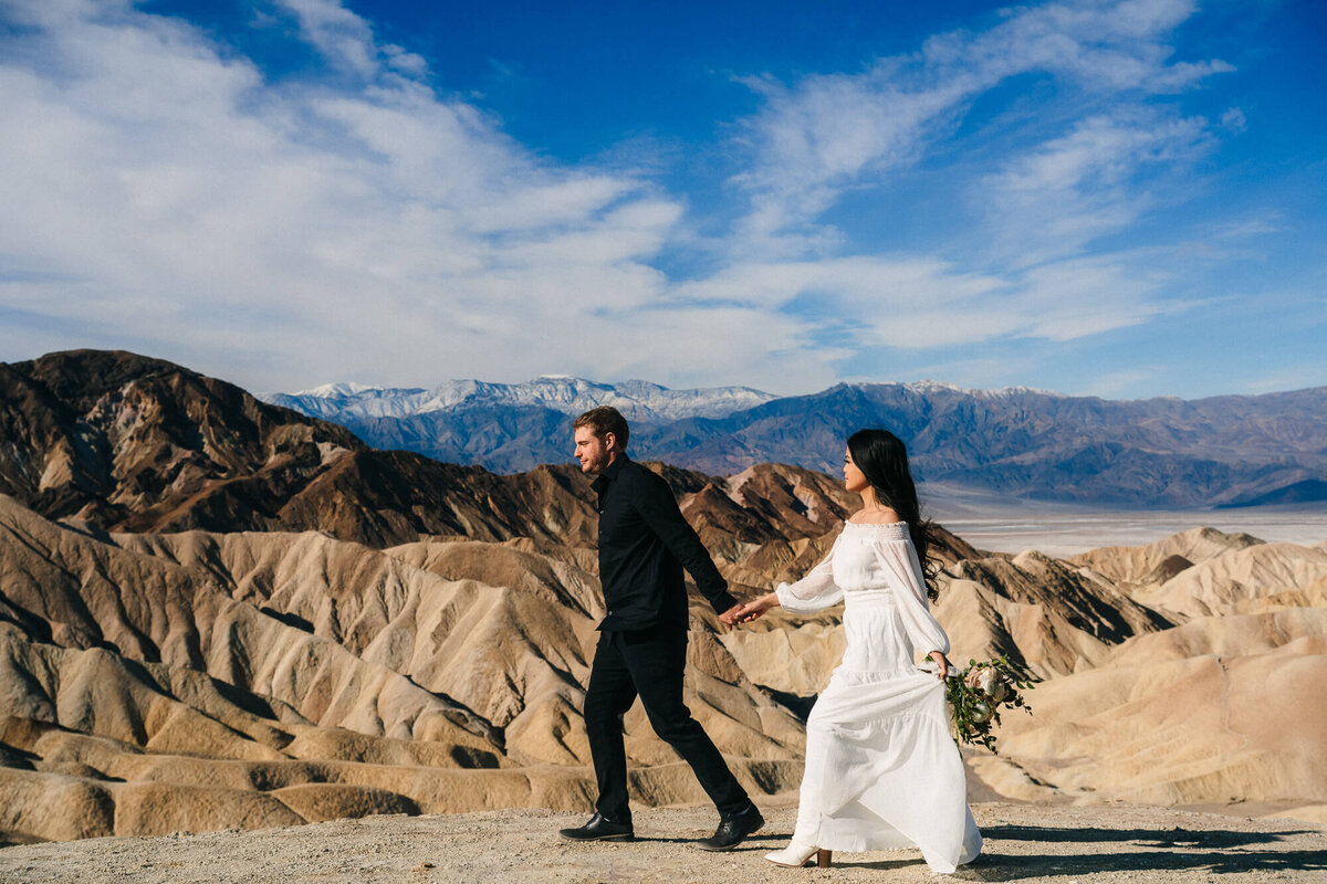 A captivating elopement photo taken at Zabriskie Point in Death Valley National Park, showcasing the stunning desert landscape as the backdrop for this special moment.