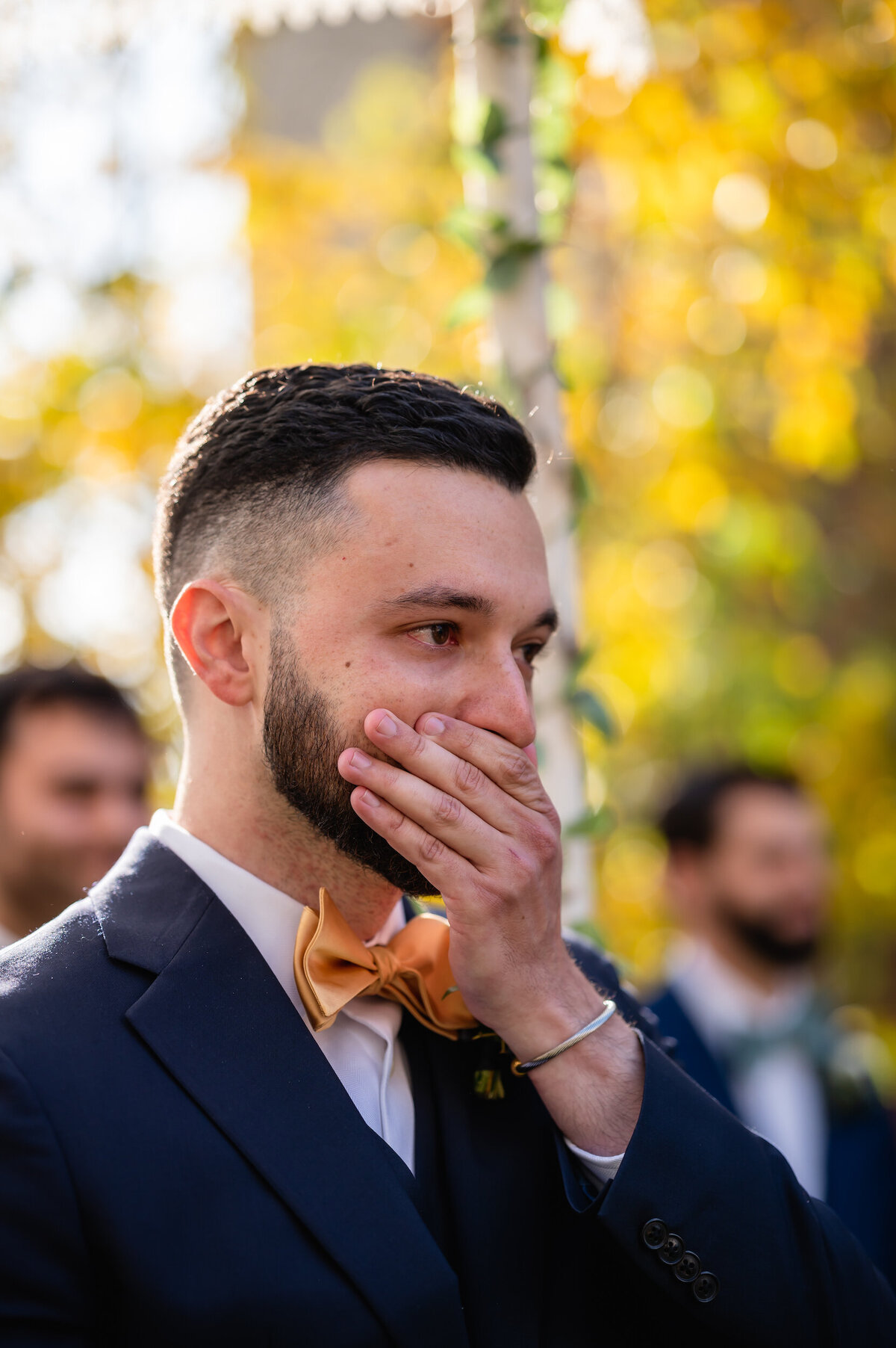 A groom expresses emotion when seeing his bride walk down the aisle at Greenhouse Loft in Chicago
