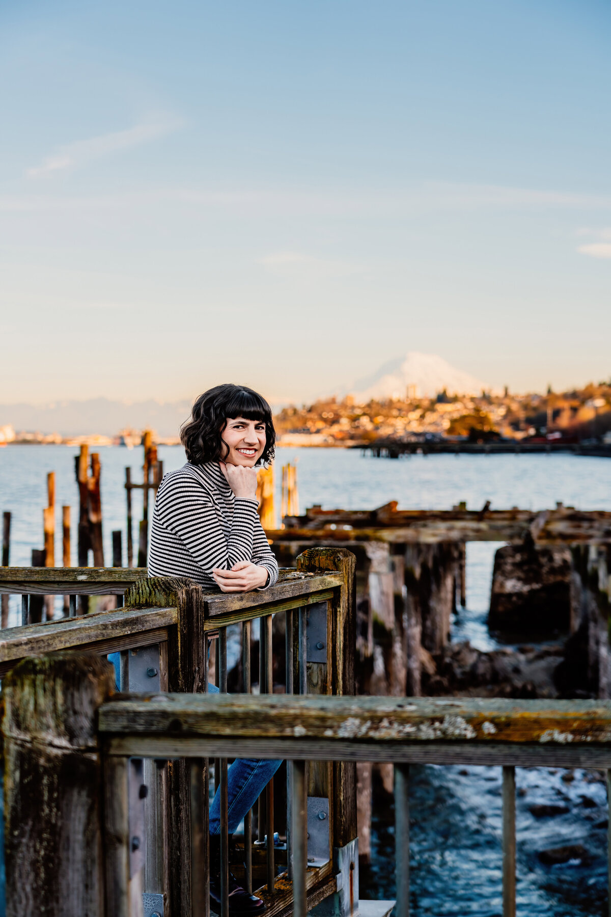 a casual headshot photoshoot for a tacoma therapist standing on a pier infront of mt rainier