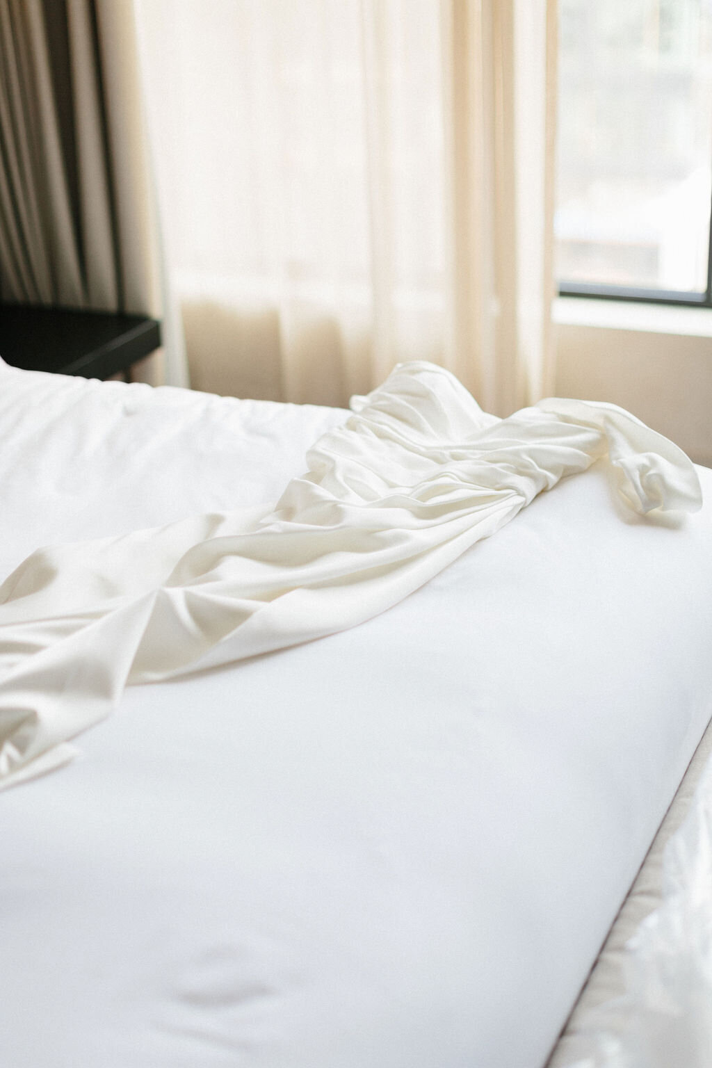 wedding dress on hotel bed