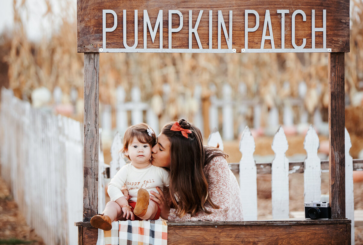 adorable sisters pose for photos at a windsor colorado pumpkin patch