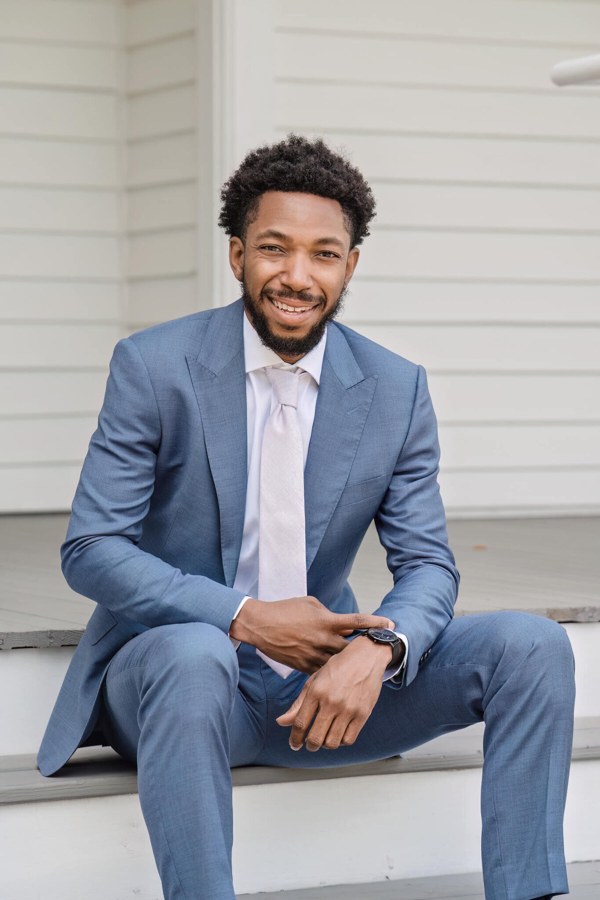 Dapper groom in a stylish blue suit posing before the wedding ceremony in Raleigh, NC.