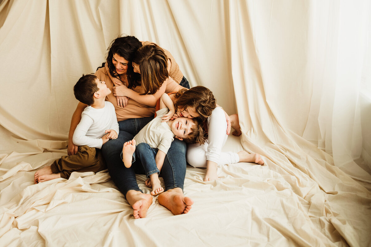 Mom with 4 children snuggled in syracuse studio