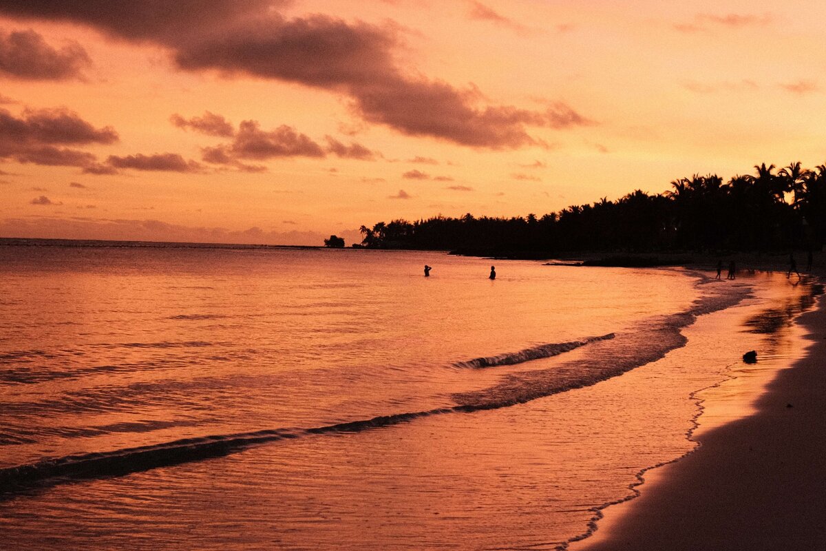 Bright pink sunset with view of ocean