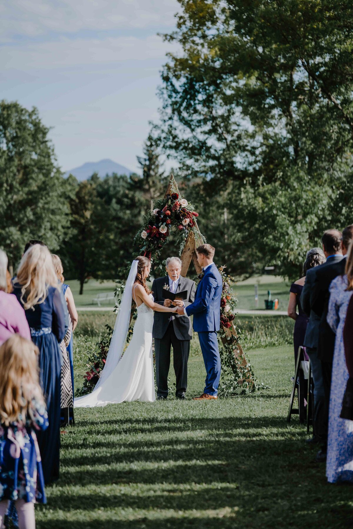 a couple at the altar at lang farm in essex vermont