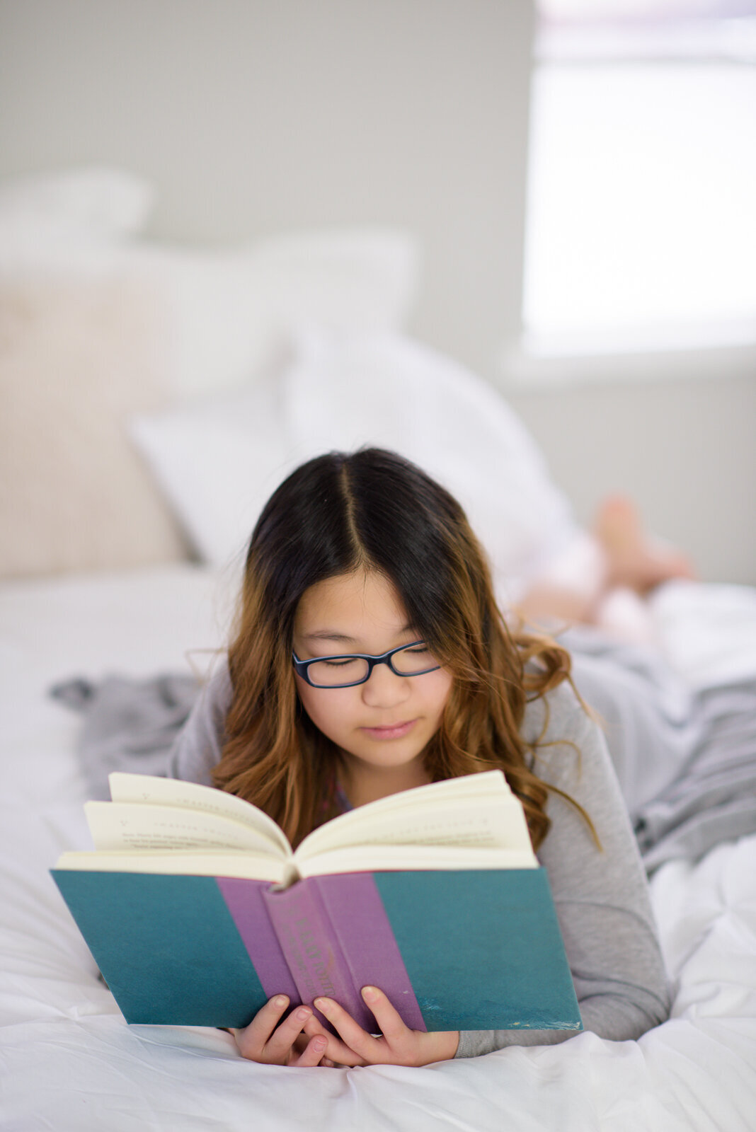 Tween girl reading in Boise photo studio.