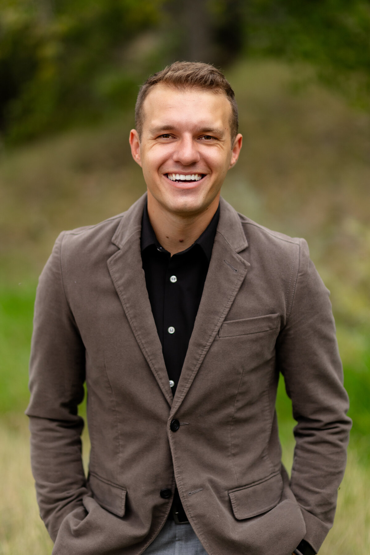 A support staff member from First National Bank of Omaha smiles for his professional headshot in Loveland, Colorado.