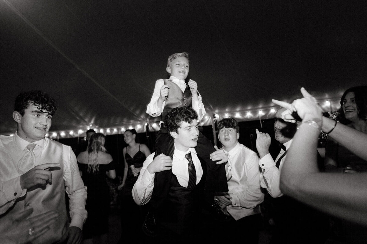A little boy and guests are dancing at the wedding reception at Lion Rock Farm, CT. Image by Jenny Fu