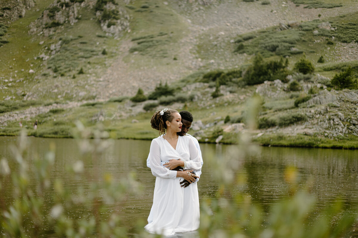 A bride and groom pose for a photo during their elopement at Loveland Pass, Colorado.