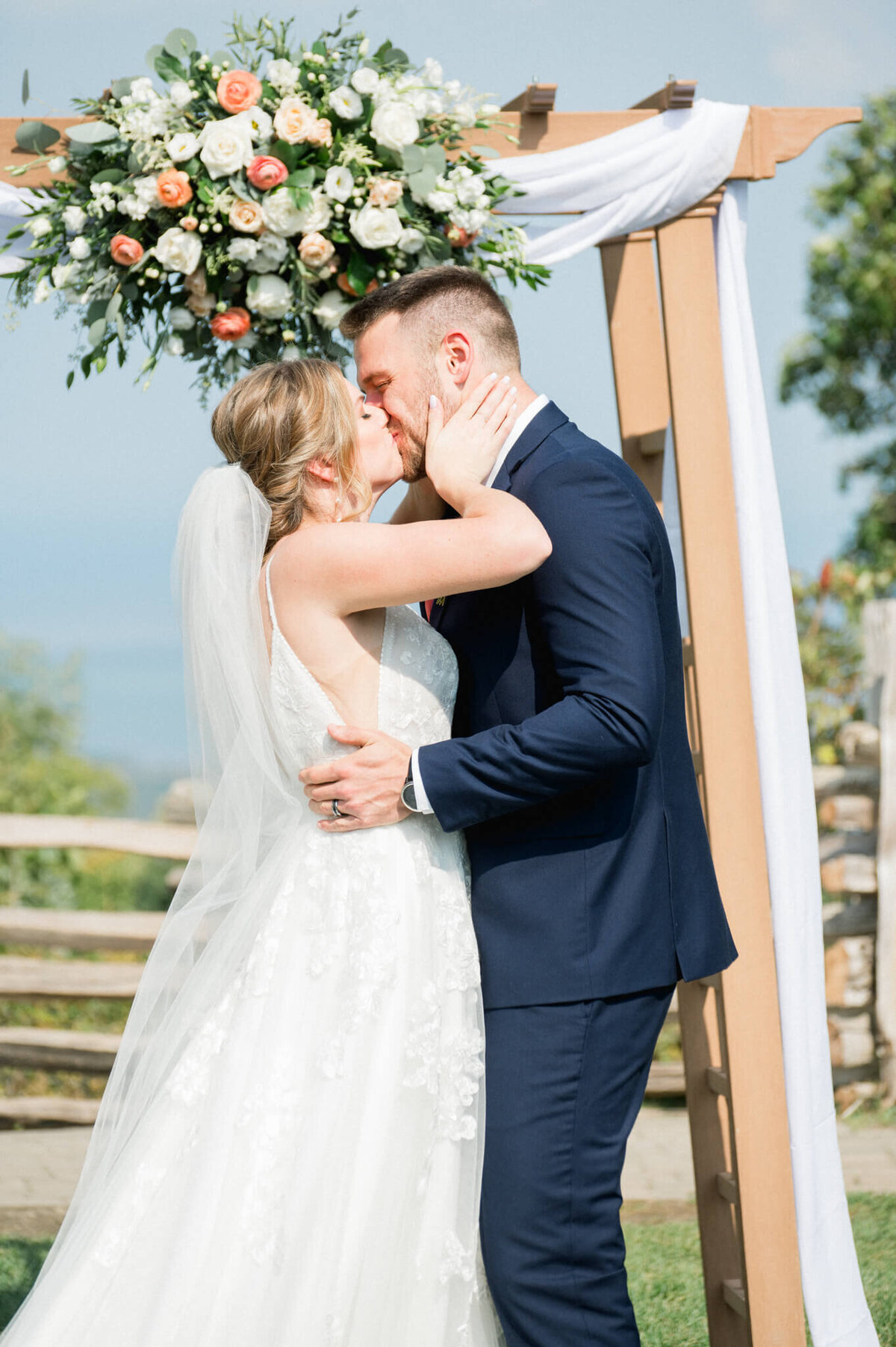 Bride and groom make their first kiss captured by Niagara wedding photographer