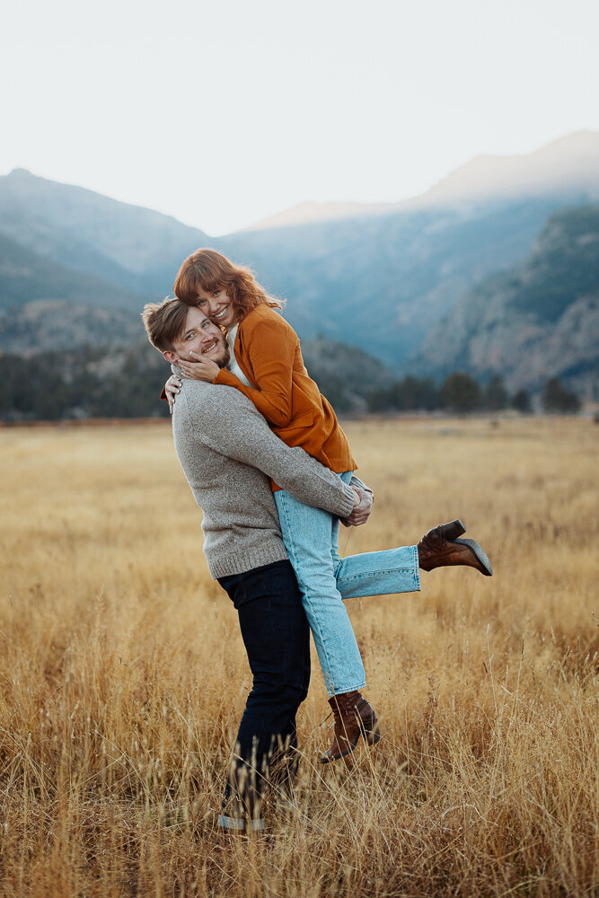 An engaged couple embraces in Rocky Mountain National Park during their engagement session.
