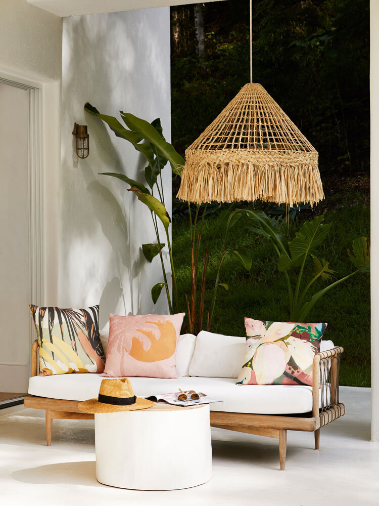 Cozy outdoor seating area with tropical print cushions styled by Melbourne interior stylist for residential design interiors.