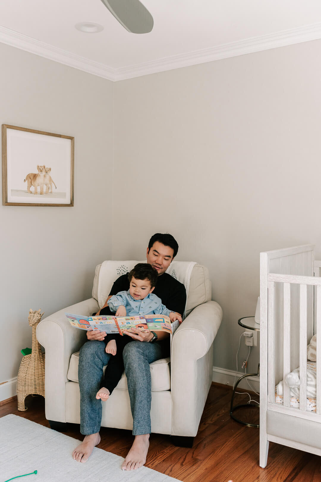 A father and son enjoying a book together in his room