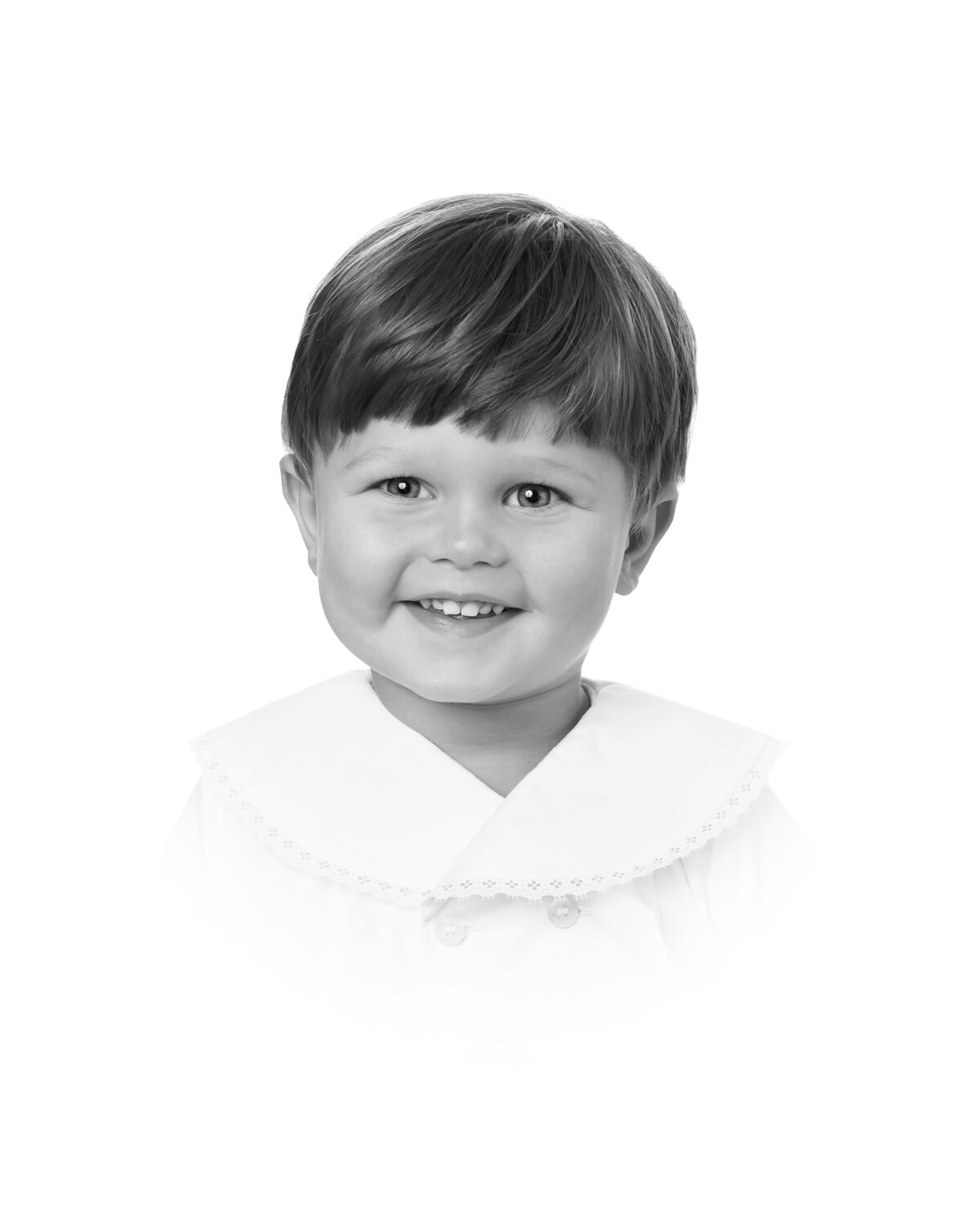 Heirloom portrait of a young boy in a vintage-style blue shirt, captured in a classic black and white vignette.