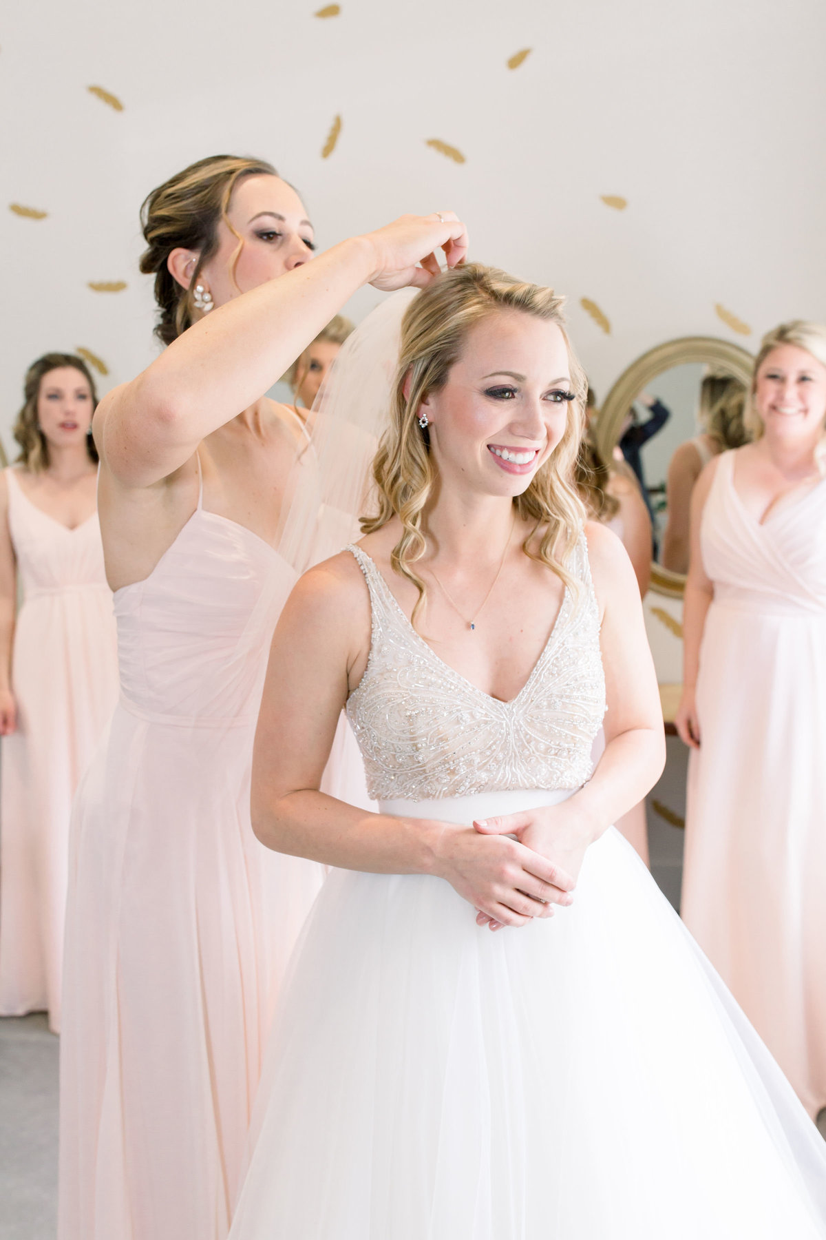 Bridesmaids fixing bride's hair in Denver, Colorado