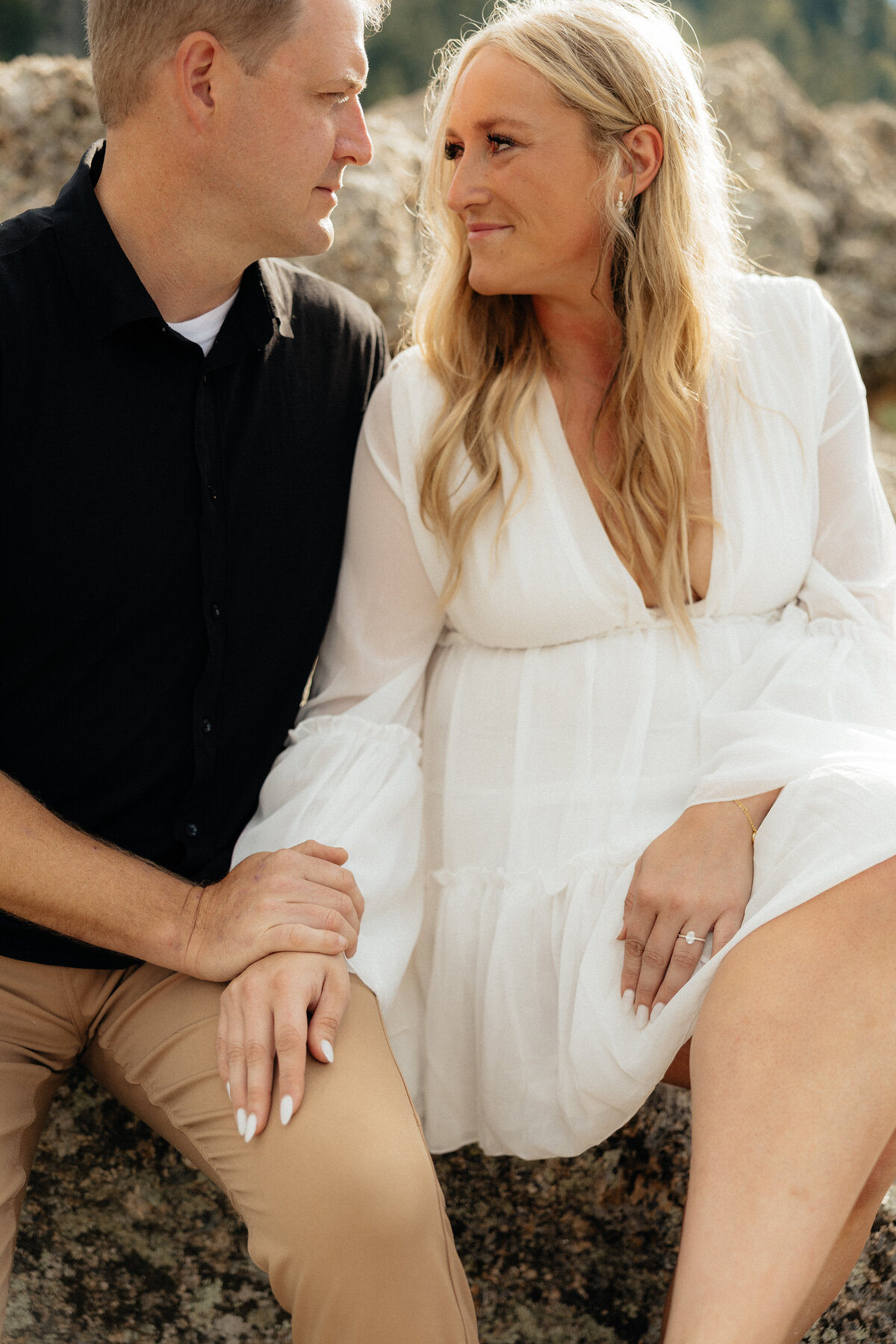 A couple looking at each other at their Sylvan Lake engagement session.