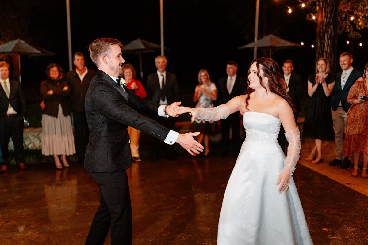 A heartwarming moment captured: a couple swaying together on the dance floor at their wedding reception, enveloped in love and joy.