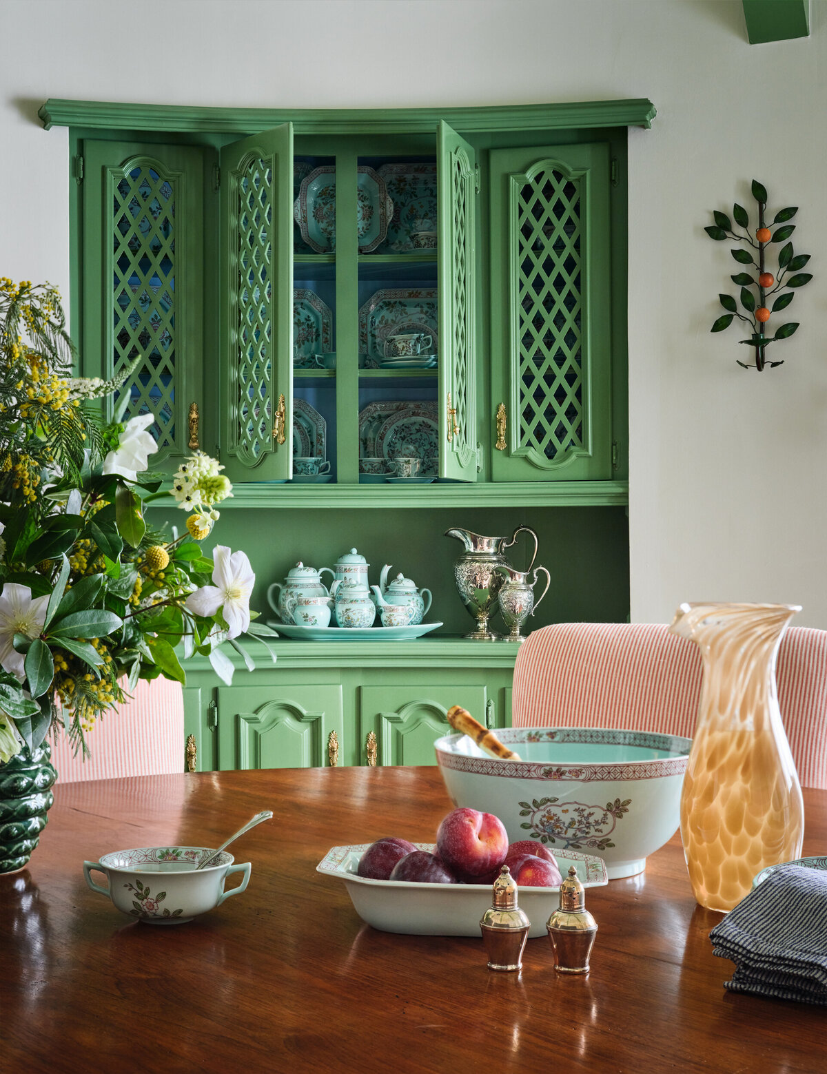 Kitchen Table with Dishes and Green Trellis Cabinets