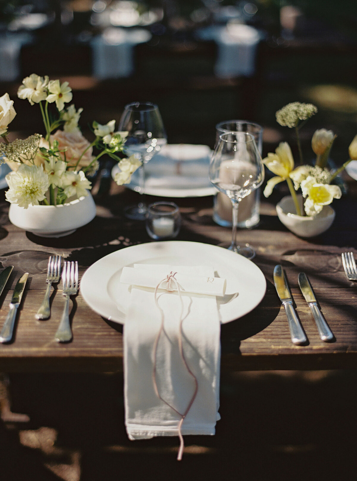 Fall wedding at Blackberry Farm. Welcome party for wedding guests at Yallerhammer Pavilion on property at Blackberry Farm. Growing floral installation with whimsical florals for entrance to reception. Rustic and earthy floral design with elegant notes of blush and cream. Wildflower design in ikebana style with glowing candlelight reception tables. Destination wedding at Blackberry Farm. Design by Rosemary & Finch Floral Design in Nashville, TN.