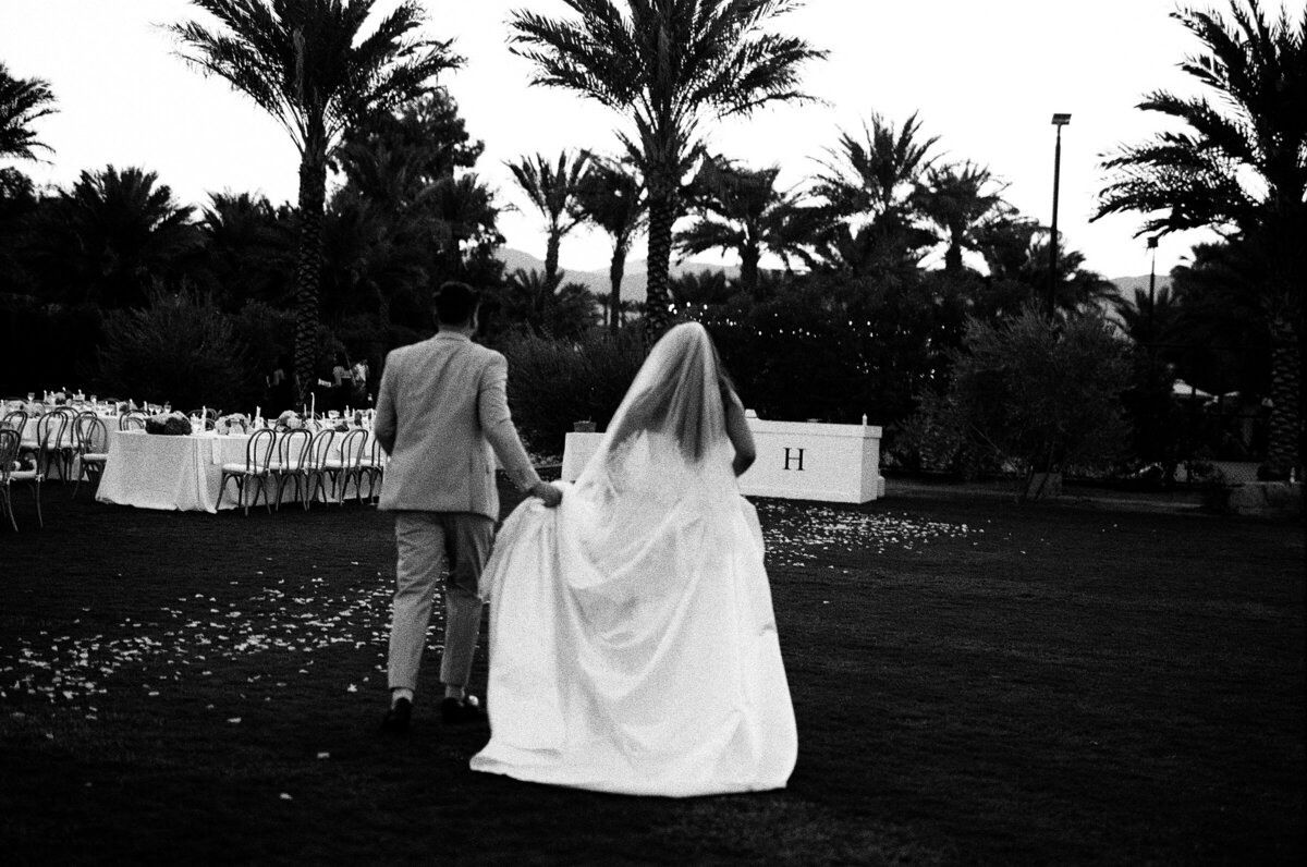 bride and groom walking away at reception shot on 35mmfilm