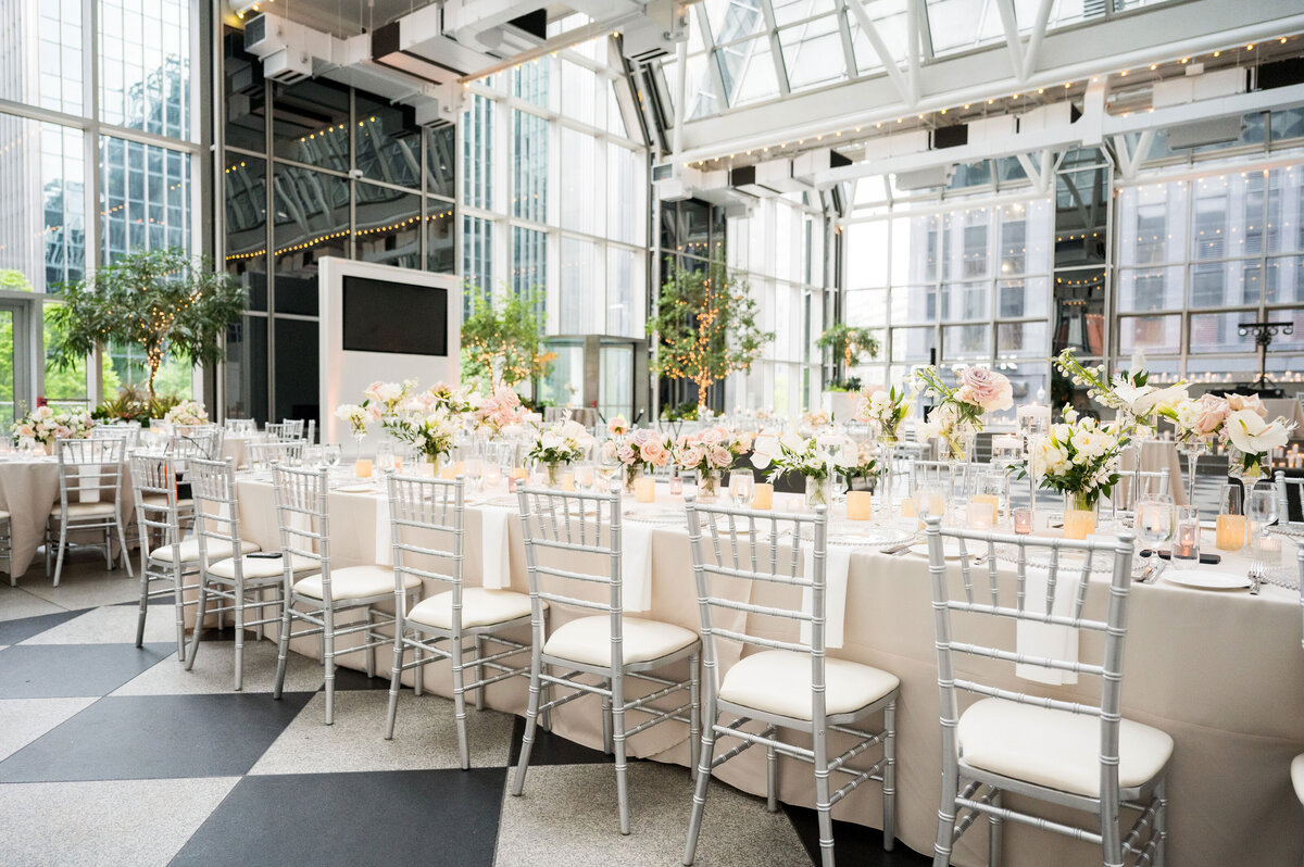 wedding reception setup with lots of white chiavari chairs at wintergarden