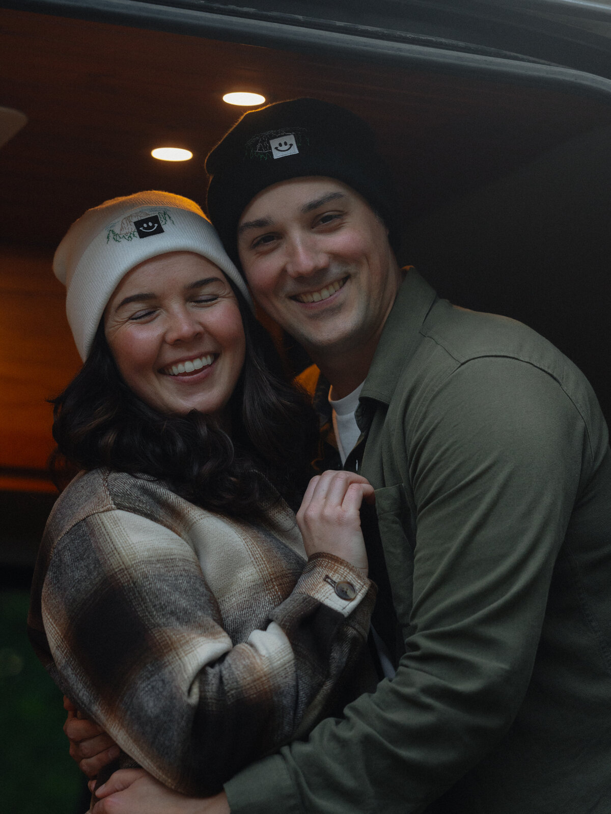 Bend, Oregon couple hugging and smiling for the camera during a playful and joyous moment