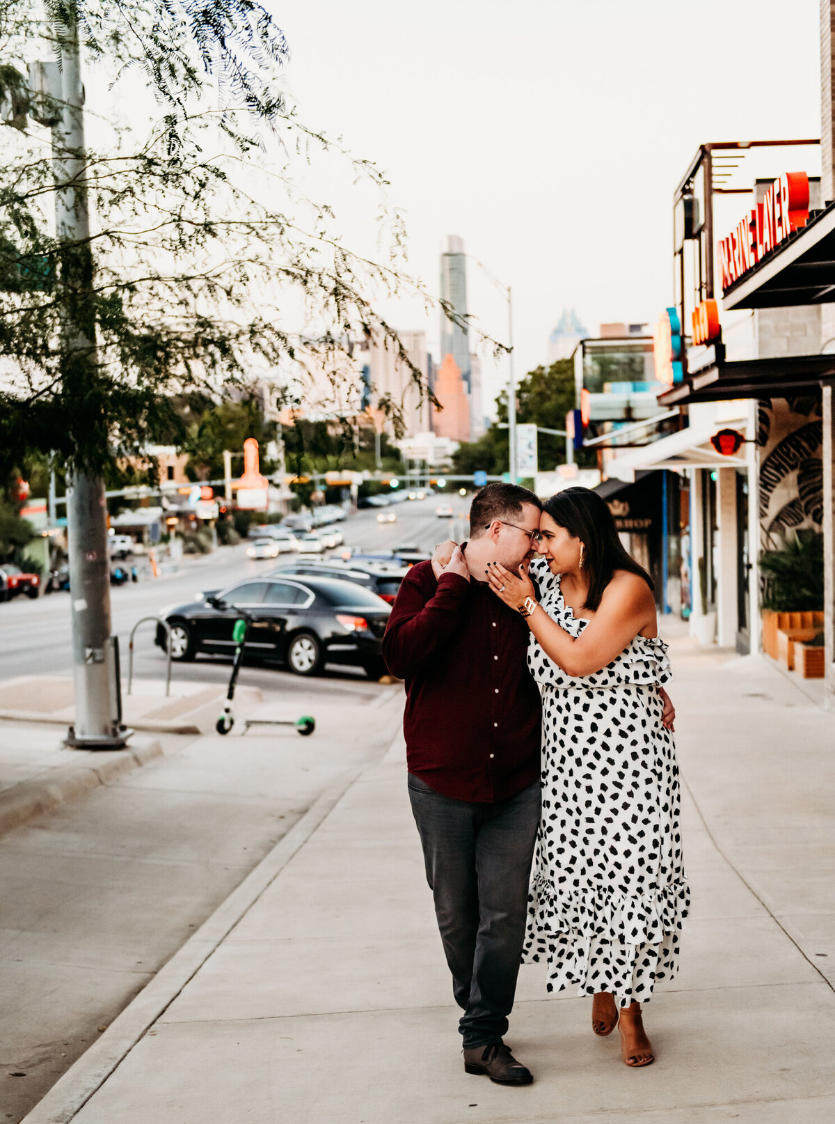 Couples Photography,  a couple walks and embraces on a city street