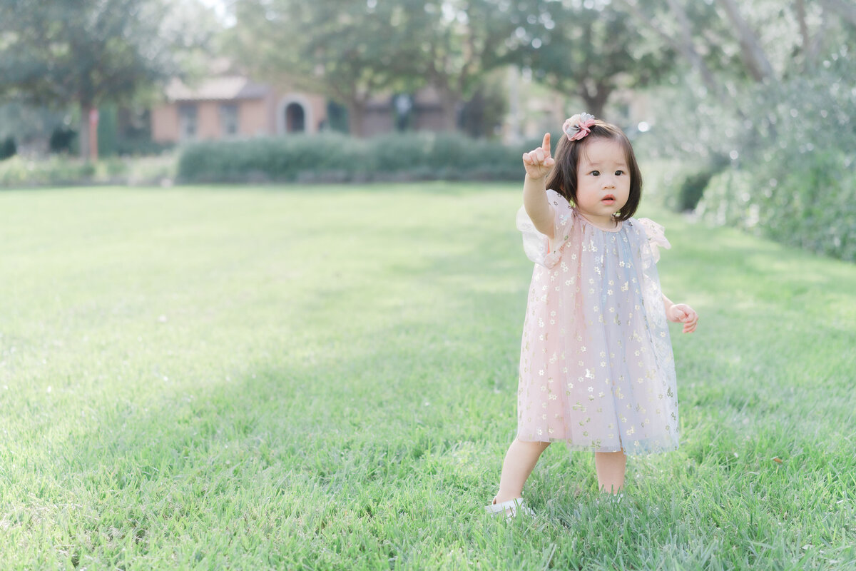 little girl walking in grass