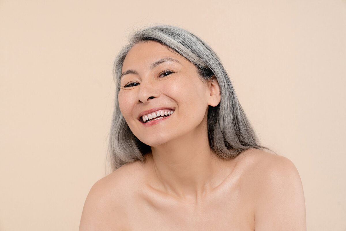 woman-with-toothy-smile-grey-hair-isolated-in-beig-2023-11-27-04-56-23-utc