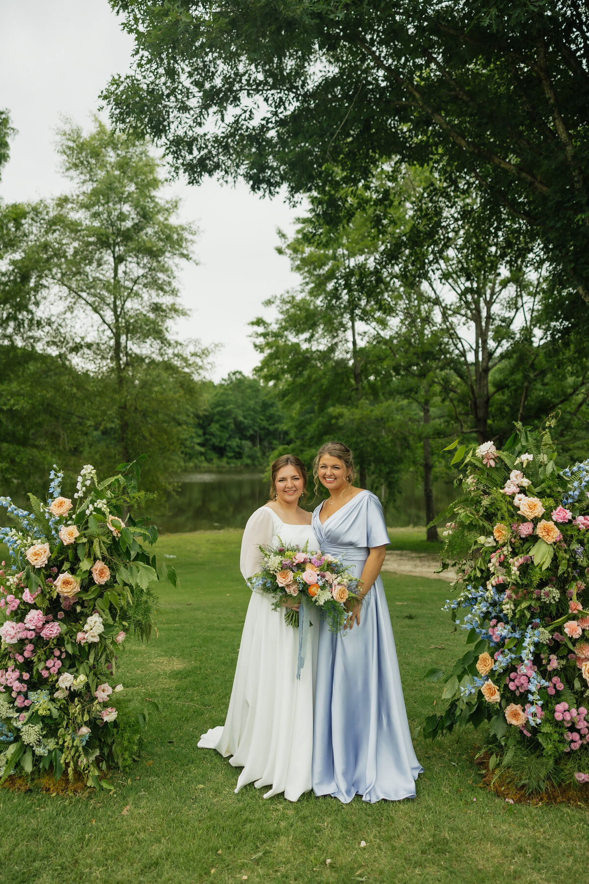 Bride and bridesmaid with colorful bouquets designed by Abby Grace Florals at Dahlonega GA wedding