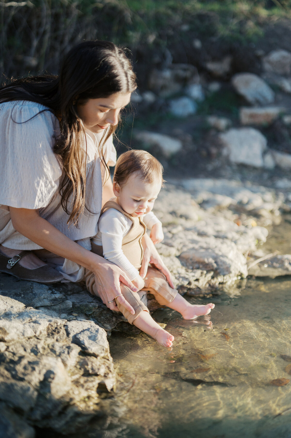 fort worth family photography, mom holds baby boy next to creek