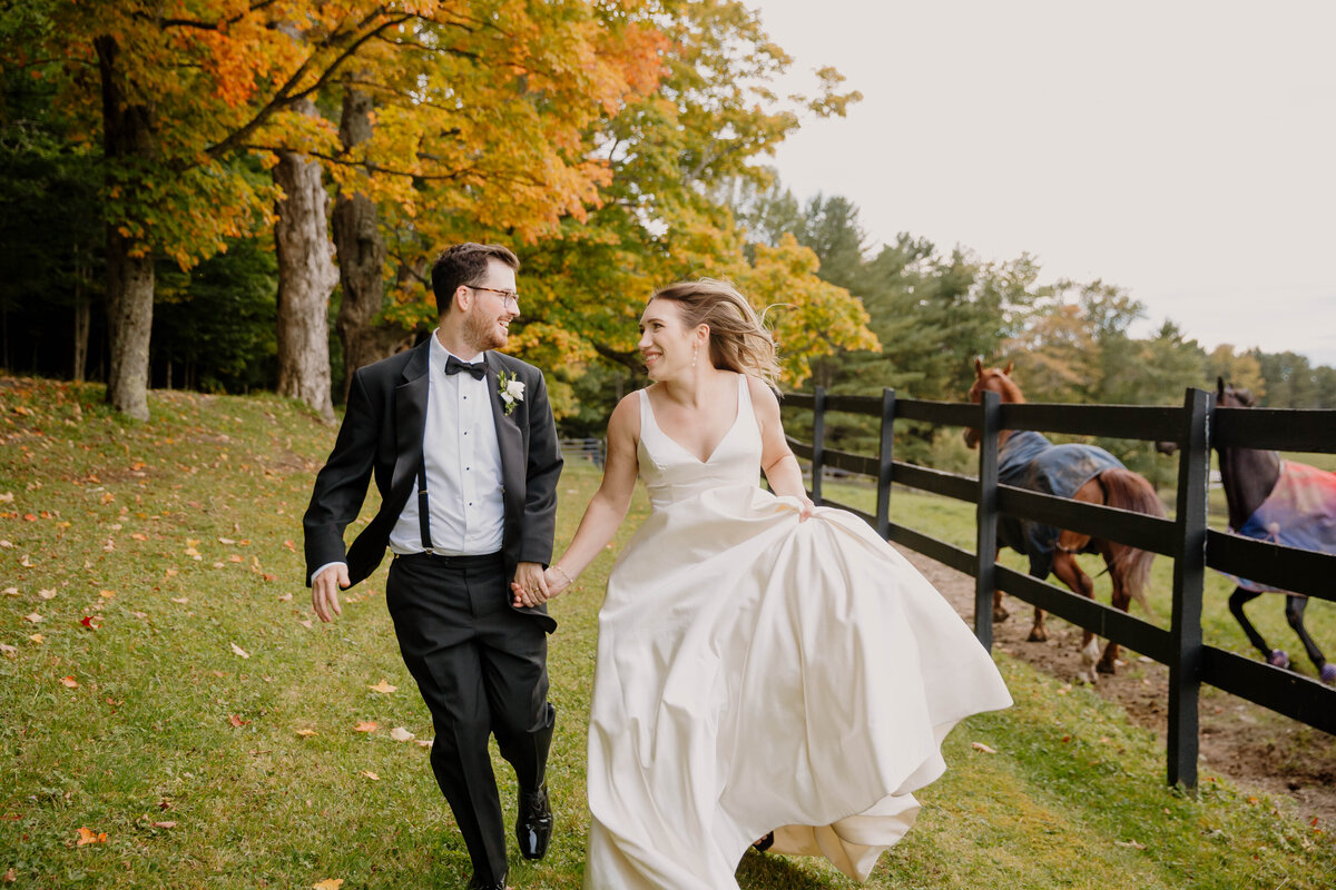 Wedding Photographer in Cooperstown NY, couple running in horse field