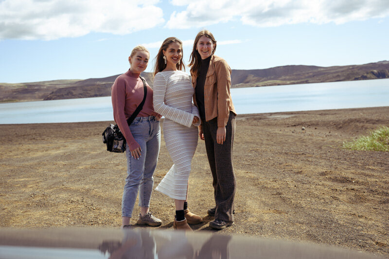 Group of three woman who are working on a photoshoot for clothing brand