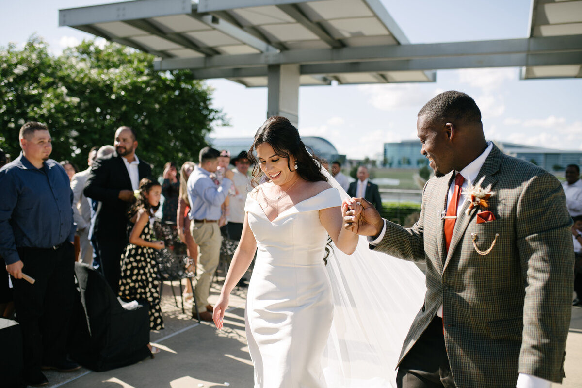 Candid moment of a bride laughing with guests at her Denver wedding reception, photographed in a documentary style.