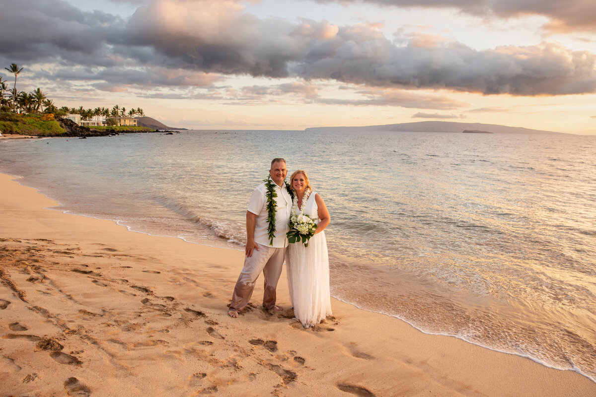 Maui Wedding Photographer captures bride and groom standing in water