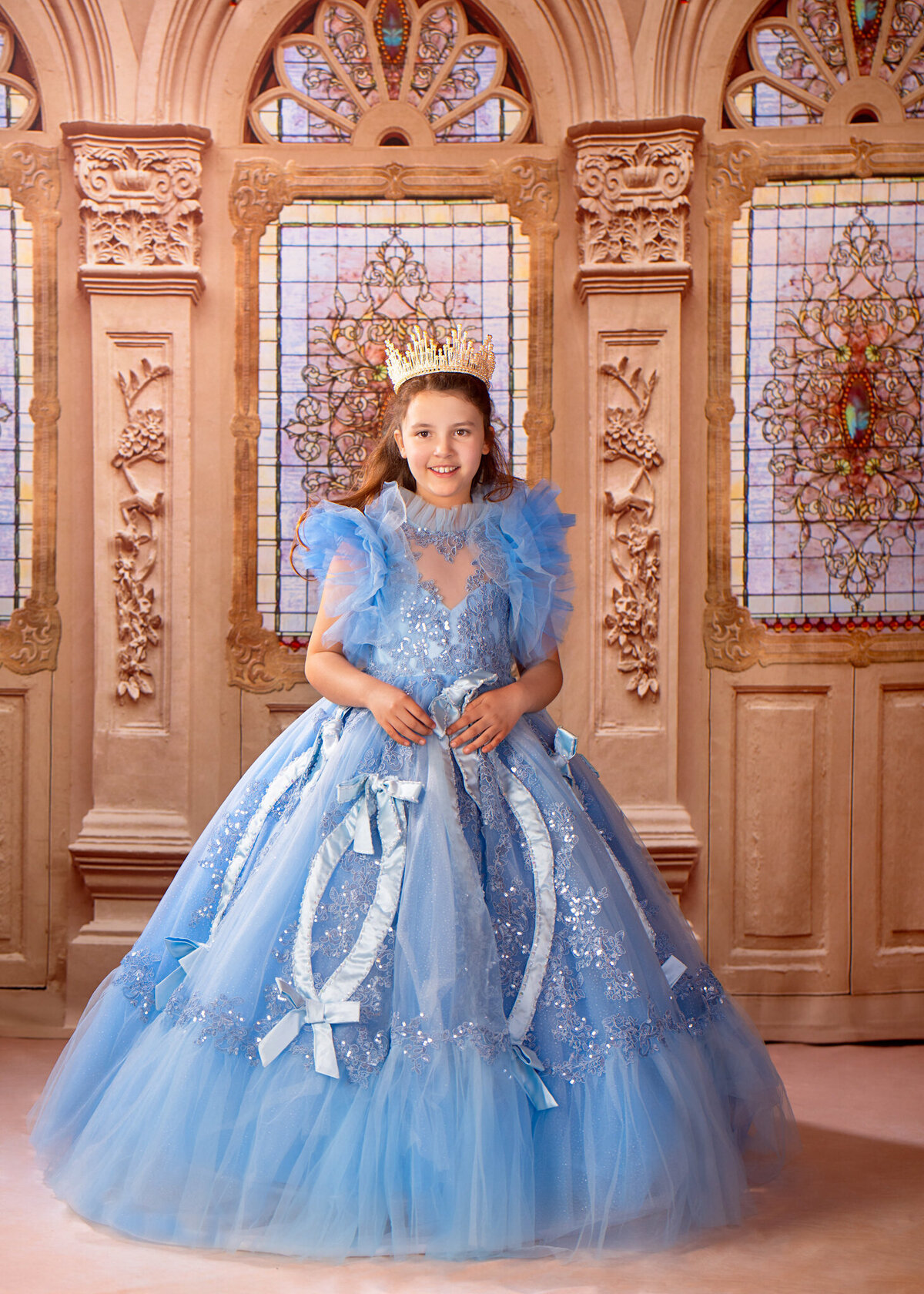 Magical portrait of a young girl dressed as Cinderella in a flowing blue gown, standing in a fairytale-inspired setting. Captured in Overland Park, Kansas, this enchanting setup is perfect for families seeking creative and storybook-themed child photography.