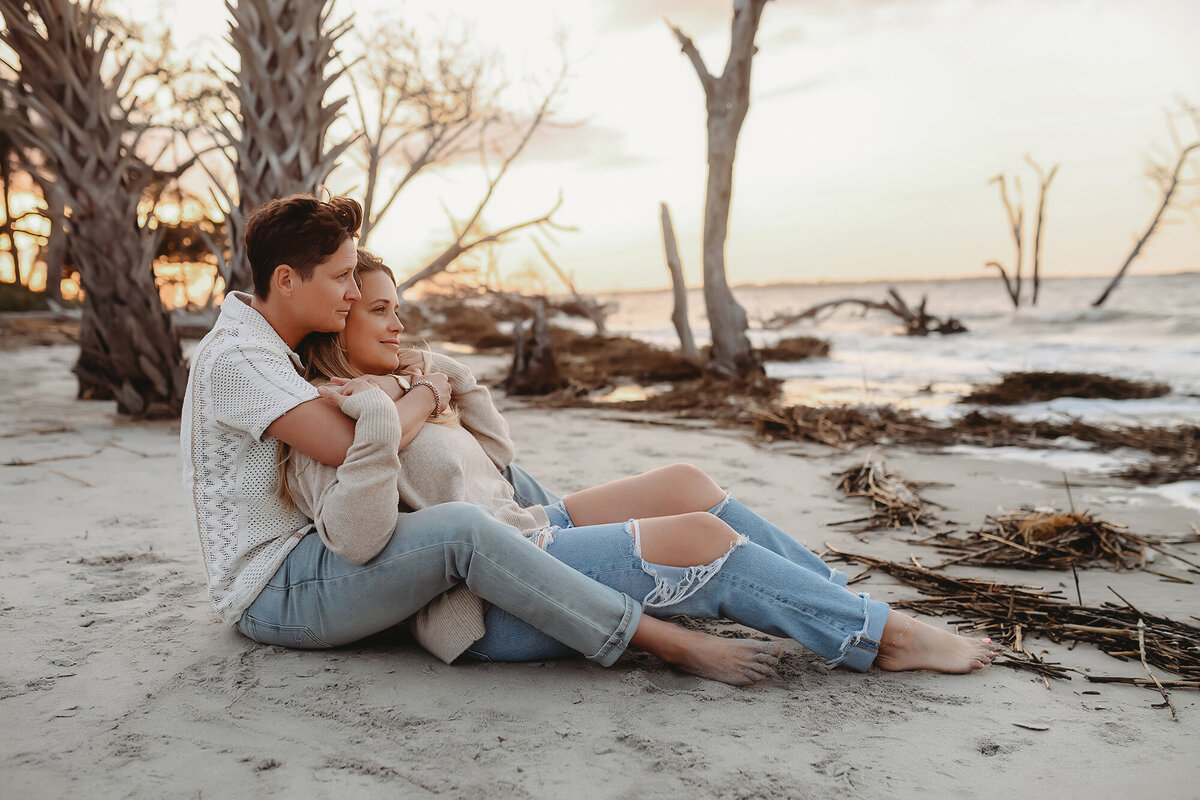 LGBTQ Friendly Photographer in Charleston, South Carolina. Same Sex couple embraces for portraits on Folly Beach.
