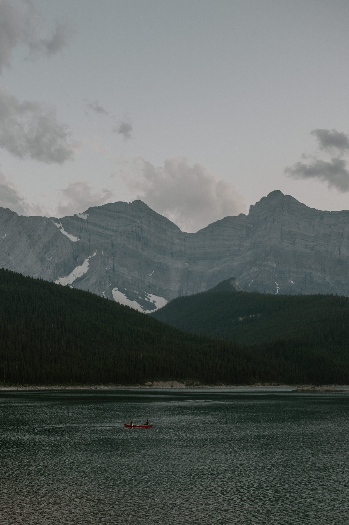couple canoeing on galcier lake in Alberta, Canada