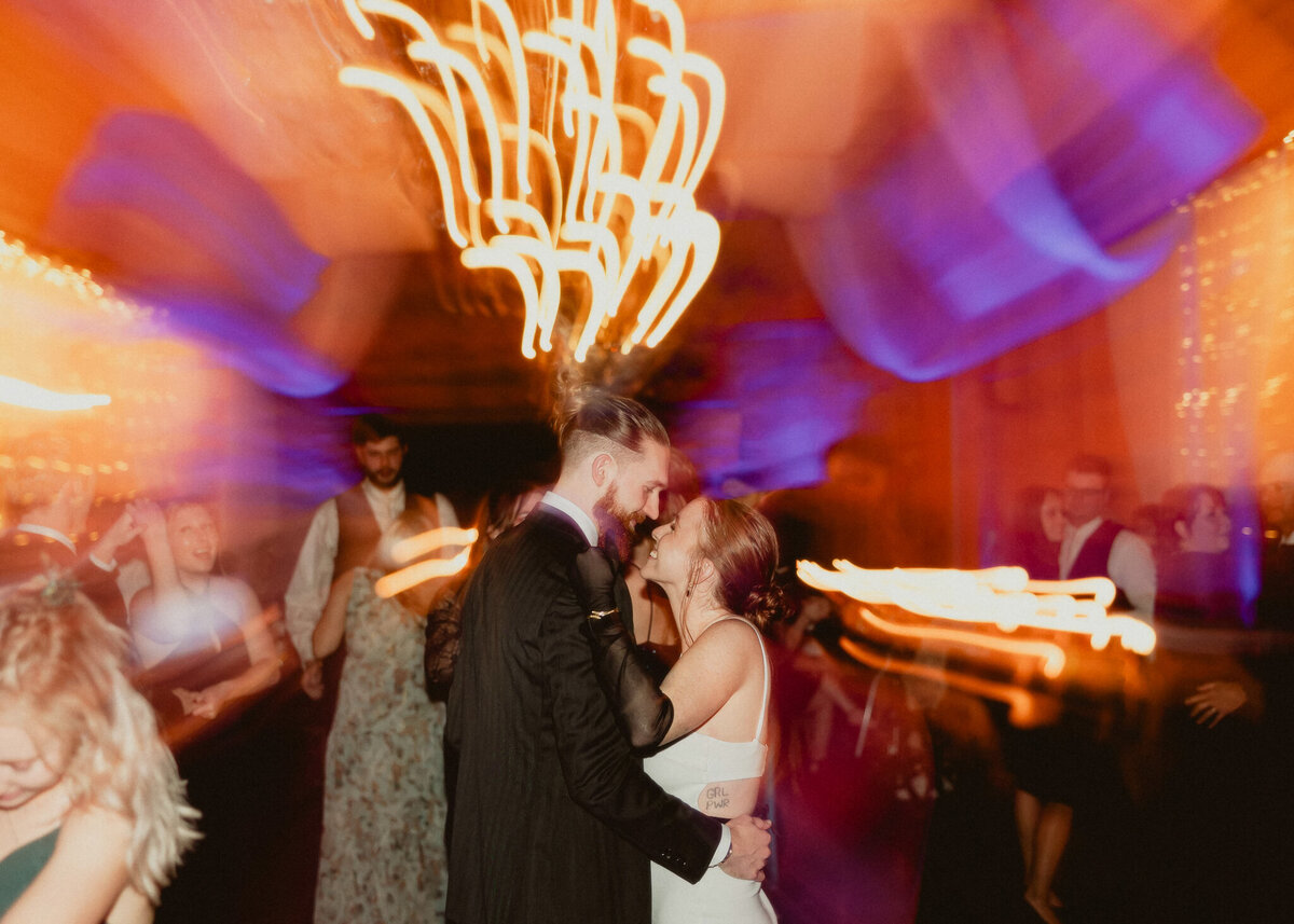 Bride and Groom dance close with creative flash blur
